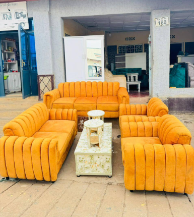 Sam Furniture orange fabric sofa set displayed at the Gikondo showroom